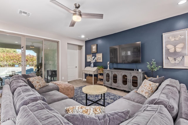 living room with light hardwood / wood-style flooring, ceiling fan, and french doors