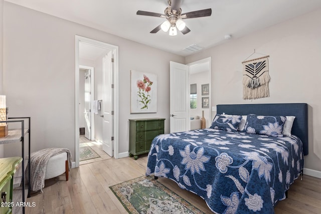 bedroom with wood-type flooring, ensuite bathroom, and ceiling fan