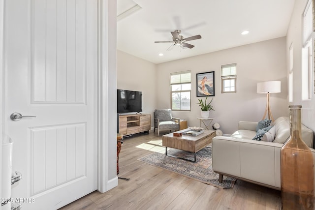 living room featuring ceiling fan and light wood-type flooring