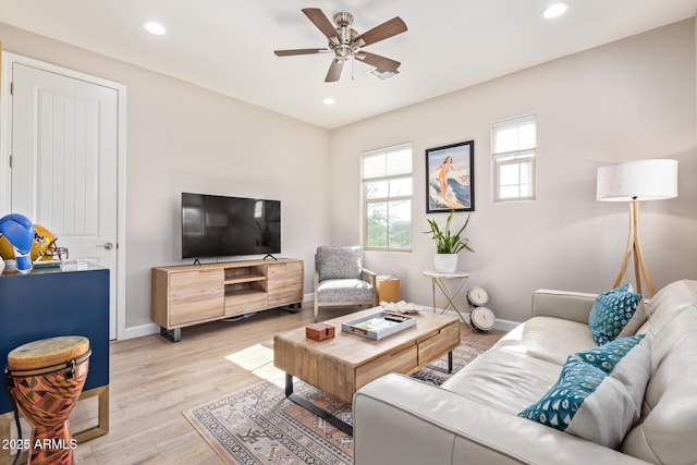 living room with ceiling fan and light wood-type flooring