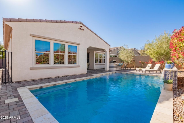 view of pool with a patio area and pool water feature