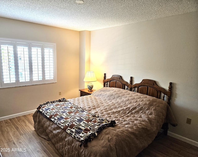 bedroom featuring wood-type flooring and a textured ceiling