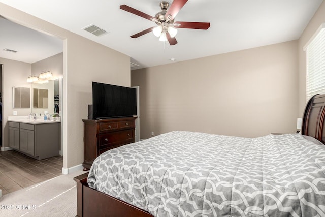 bedroom featuring a ceiling fan, baseboards, visible vents, and light wood finished floors