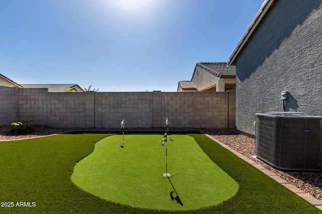view of yard featuring central AC unit and a fenced backyard