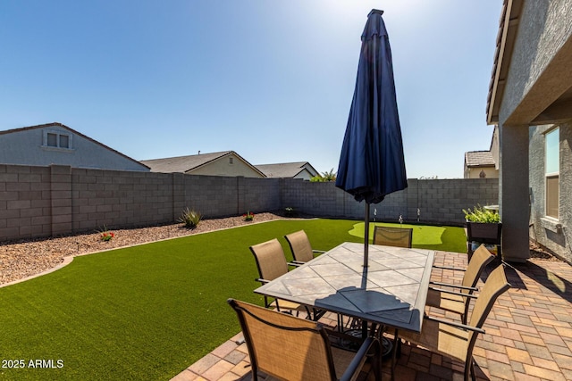 view of patio featuring outdoor dining area and a fenced backyard