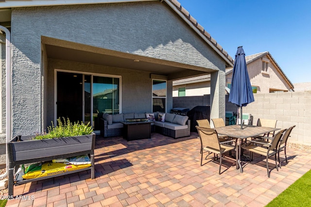 view of patio with an outdoor living space, outdoor dining area, and fence