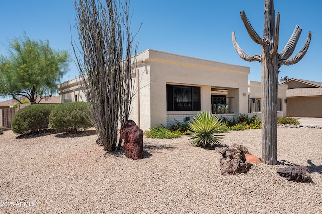 rear view of property with stucco siding