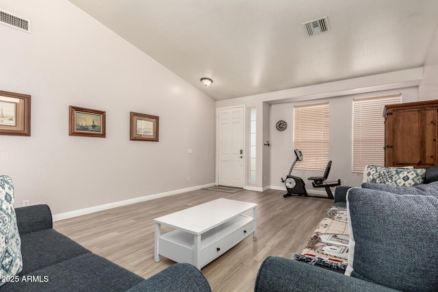 living room with vaulted ceiling and light hardwood / wood-style floors