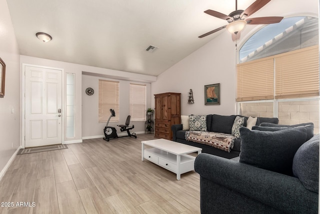 living room featuring vaulted ceiling, ceiling fan, and light wood-type flooring