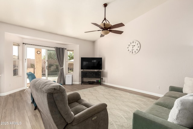 living room featuring hardwood / wood-style floors and ceiling fan