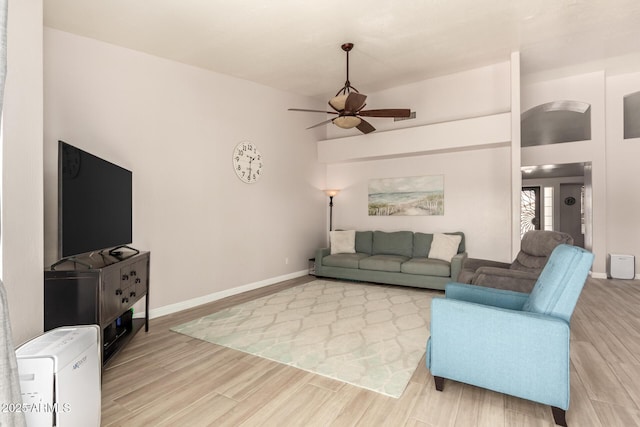 living room with light hardwood / wood-style flooring and ceiling fan