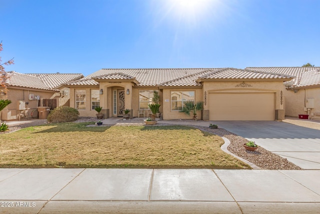 mediterranean / spanish house with a garage and a front lawn