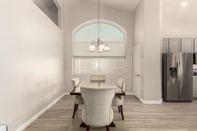 dining room featuring a chandelier, high vaulted ceiling, and a wealth of natural light