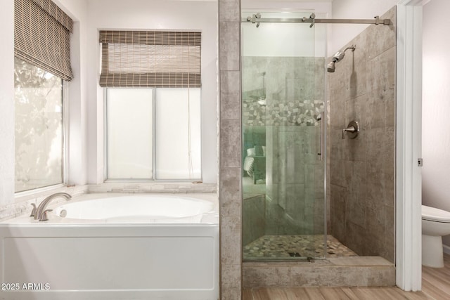 bathroom with toilet, independent shower and bath, and hardwood / wood-style floors