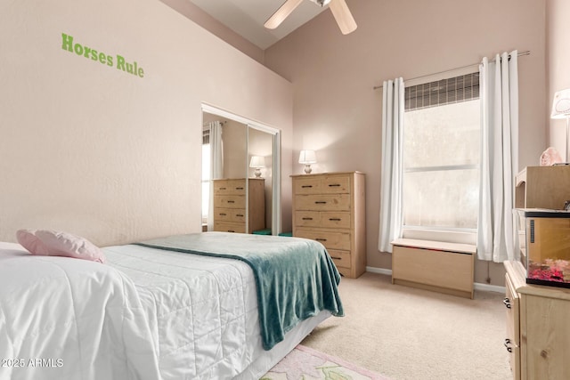 bedroom with lofted ceiling, light carpet, and ceiling fan