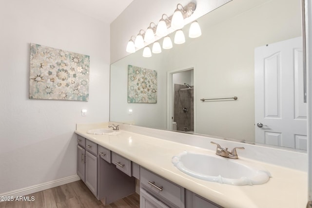 bathroom featuring hardwood / wood-style flooring, vanity, toilet, and walk in shower