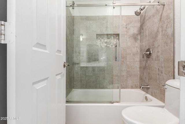 bathroom with enclosed tub / shower combo and toilet