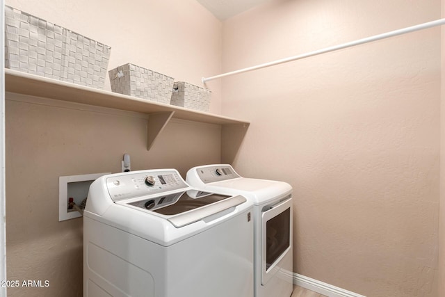 clothes washing area featuring washer and dryer