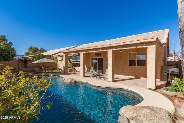 view of pool featuring ceiling fan, grilling area, and a patio