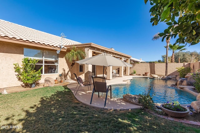 view of swimming pool featuring a lawn and a patio area