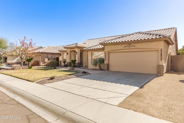 mediterranean / spanish-style house with a garage and a front yard