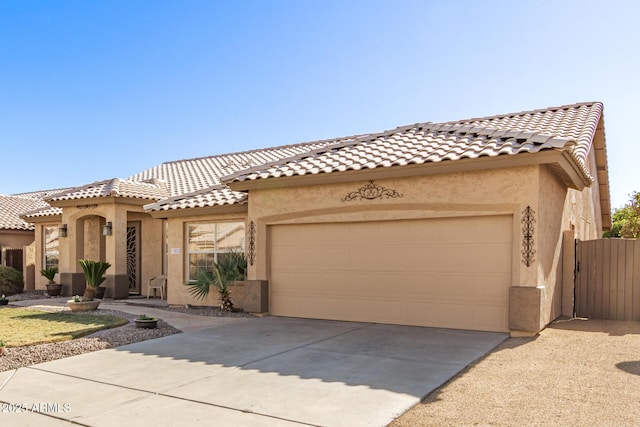 mediterranean / spanish-style home with a garage