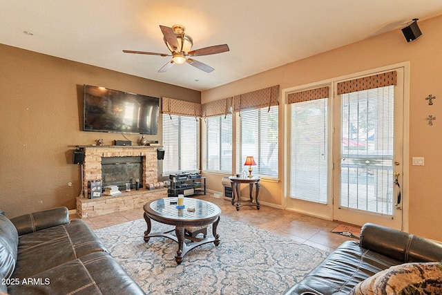 4554 W Detroit St, Chandler, AZ 85226 - living area featuring tile patterned floors, baseboards, a ceiling fan, and a stone fireplace