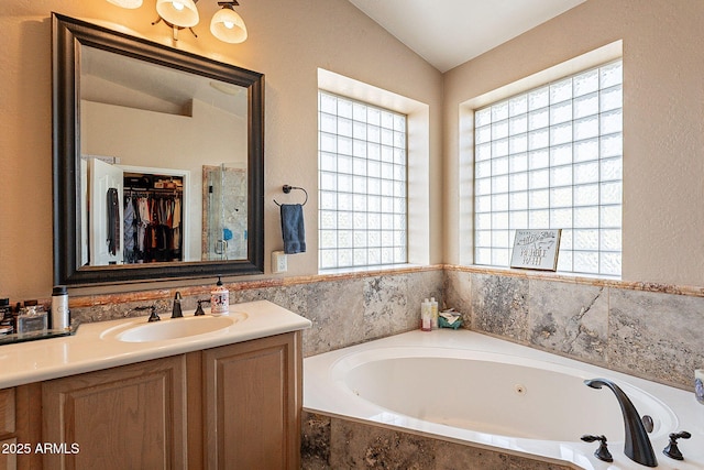 4554 W Detroit St, Chandler, AZ 85226 - bathroom featuring a garden tub, vanity, and vaulted ceiling