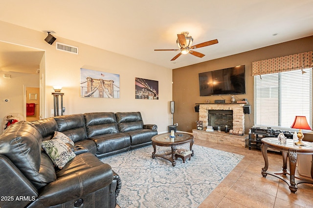 4554 W Detroit St, Chandler, AZ 85226 - living area with light tile patterned floors, a stone fireplace, a ceiling fan, and visible vents