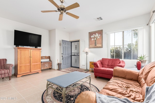 living room featuring light tile patterned floors, visible vents, and a ceiling fan