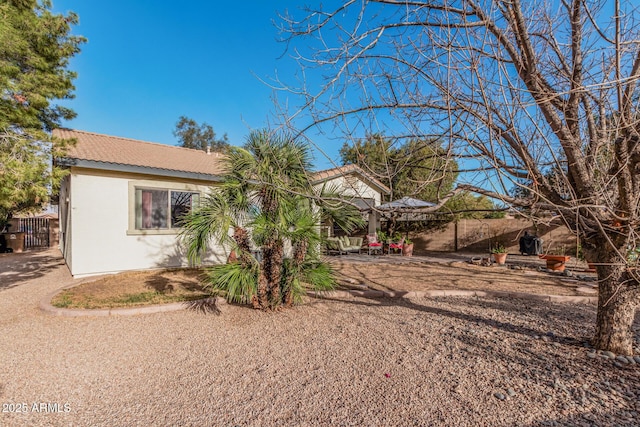 view of front of house with fence and stucco siding