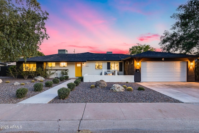 ranch-style house with a garage and concrete driveway