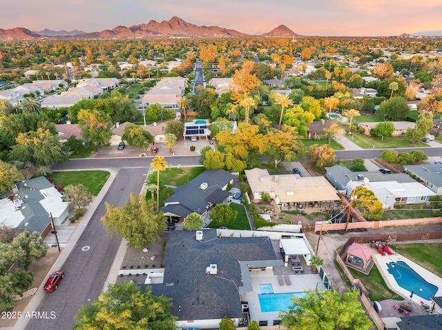 aerial view at dusk featuring a residential view and a mountain view