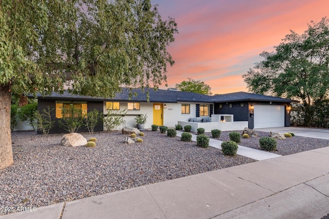 view of front facade featuring an attached garage and concrete driveway