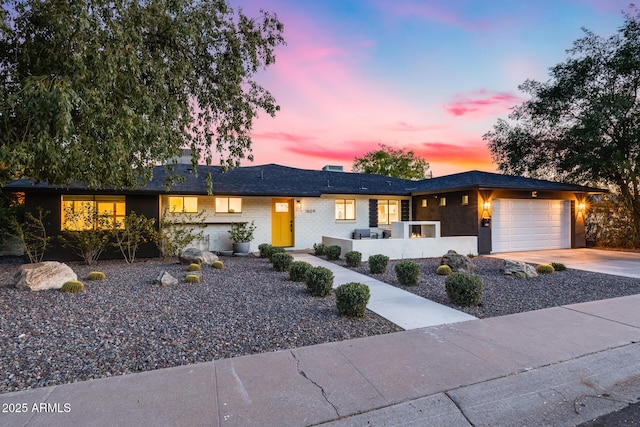 ranch-style house featuring an attached garage and driveway