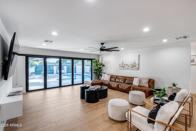 living room with ceiling fan, recessed lighting, and visible vents