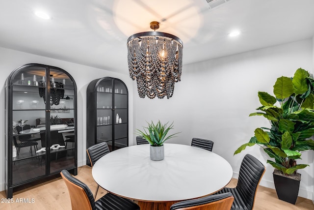 dining area featuring an inviting chandelier, recessed lighting, light wood-type flooring, and visible vents