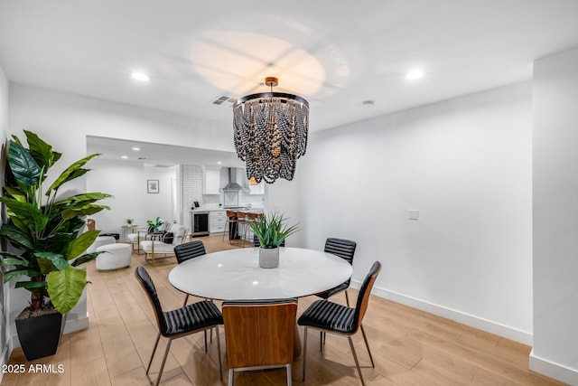 dining room with visible vents, baseboards, a chandelier, light wood-style floors, and recessed lighting