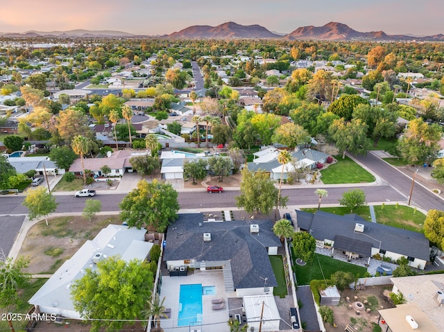 aerial view at dusk featuring a residential view and a mountain view