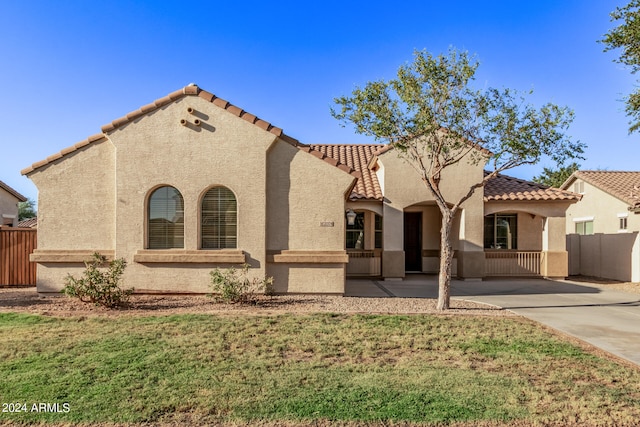 mediterranean / spanish-style house featuring a front yard