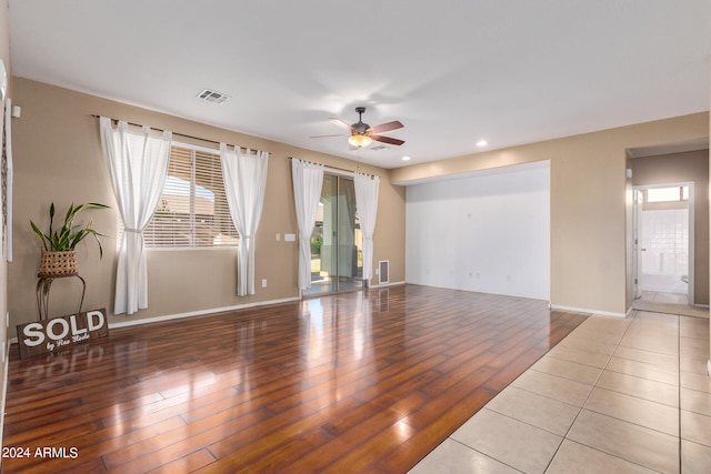 spare room featuring light wood-type flooring and ceiling fan