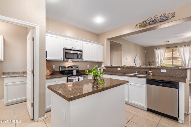 kitchen featuring a kitchen island, white cabinetry, and stainless steel appliances