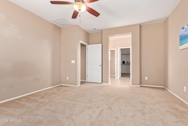 unfurnished bedroom featuring ceiling fan and light carpet