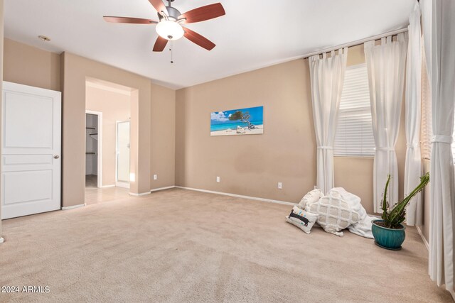 carpeted empty room featuring ceiling fan