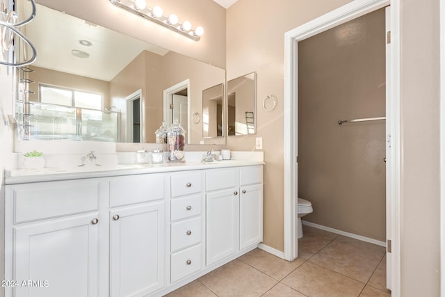 bathroom with tile patterned flooring, vanity, and toilet