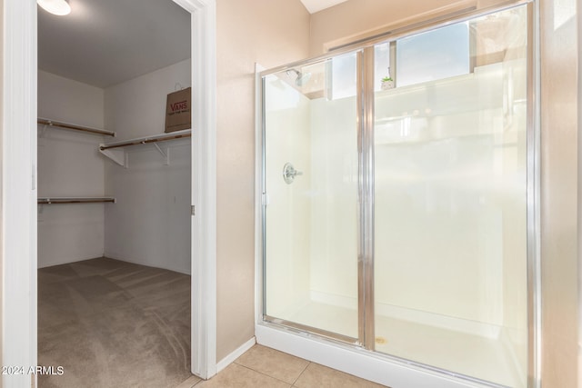 bathroom with tile patterned flooring and an enclosed shower