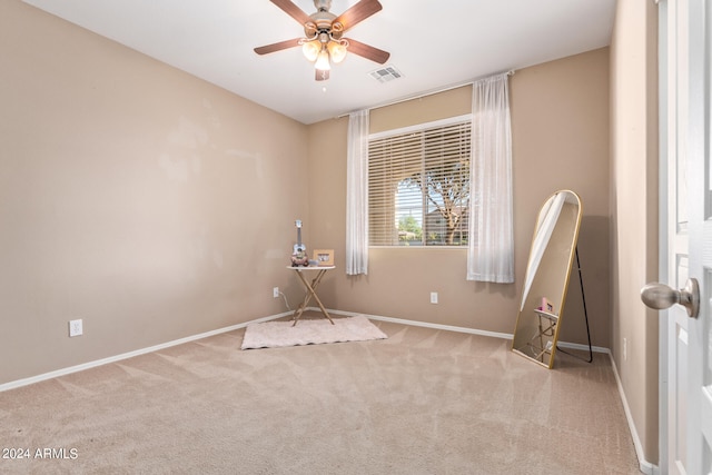 unfurnished room featuring ceiling fan and light colored carpet