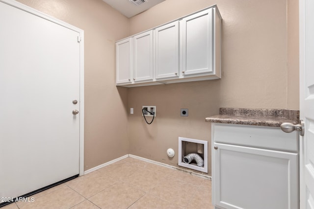 laundry room featuring cabinets, light tile patterned flooring, electric dryer hookup, hookup for a gas dryer, and hookup for a washing machine