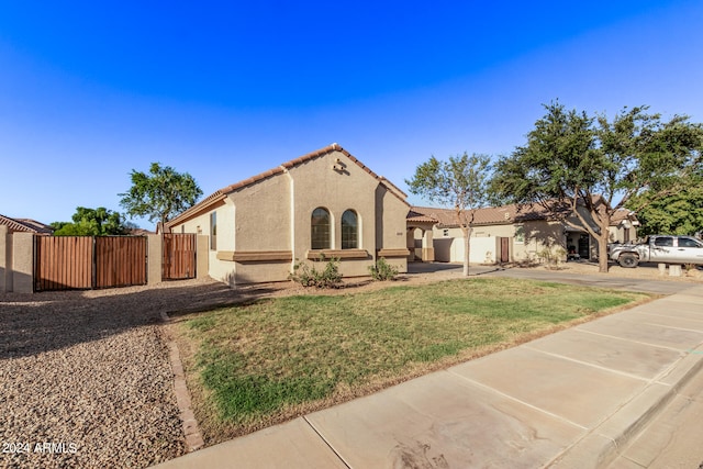 mediterranean / spanish-style house with a front yard