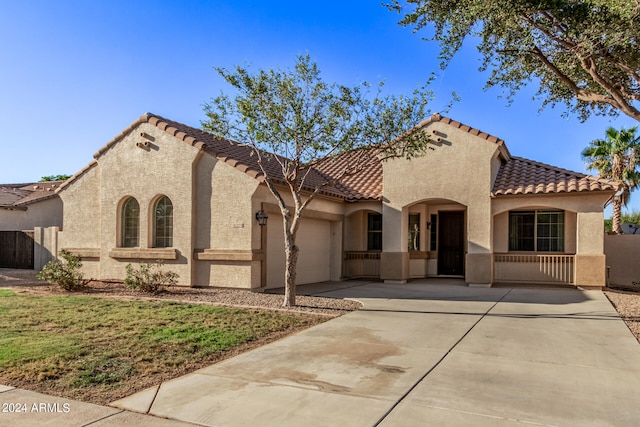 mediterranean / spanish-style home featuring a garage